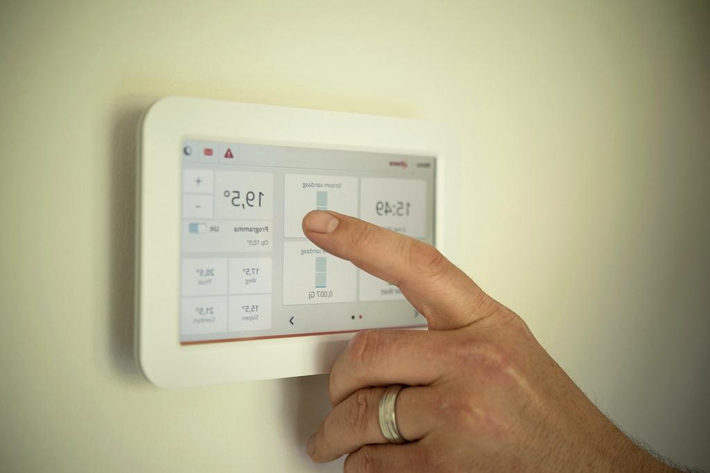 Smart thermostat mounted on modern wall